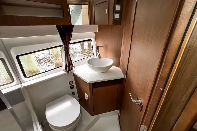  Yacht Photos Pics Luxurious bathroom interior of 2022 Beneteau Antares 11 Fly yacht with modern fixtures.