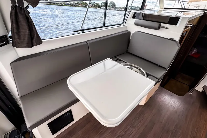  Yacht Photos Pics Interior of 2022 Beneteau Antares 11 Fly with sleek seating and table setup.