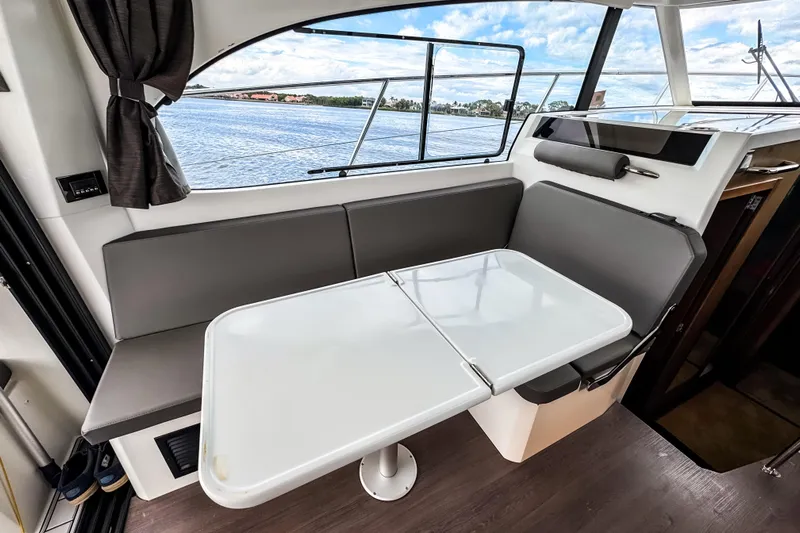  Yacht Photos Pics Interior of 2022 Beneteau Antares 11 Fly with dining area and scenic window view.