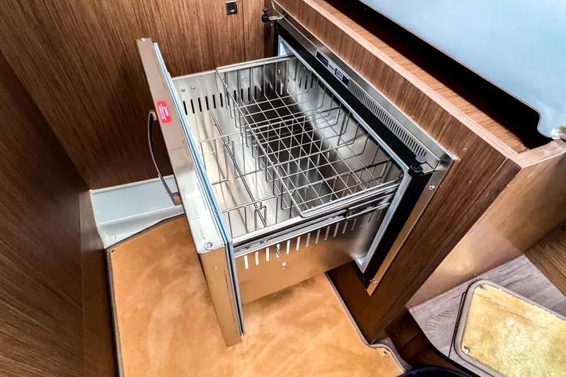  Yacht Photos Pics Beneteau Antares 11 Fly 2022 interior with open stainless steel drawer fridge.