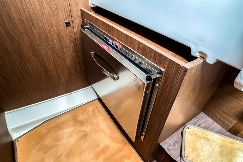  Yacht Photos Pics Interior of 2022 Beneteau Antares 11 Fly with compact stainless steel fridge.