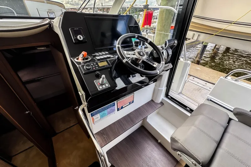  Yacht Photos Pics 2022 Beneteau Antares 11 Fly helm with modern controls and navigation display.