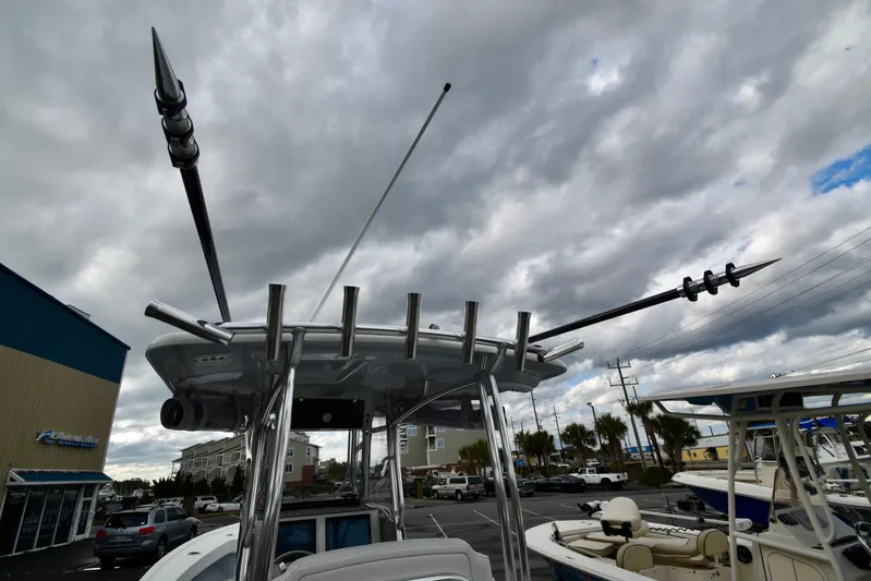  Yacht Photos Pics 2023 Pair Customs 24 Deep V boat with antennas under cloudy sky.