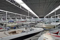 Indoor boat storage with multiple boats, including a 2016 Cobalt 24, under a covered facility.