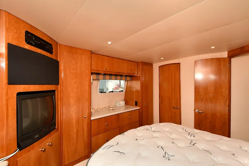  Yacht Photos Pics Luxurious interior of 2001 Carver 466 Motor Yacht with wood cabinetry and cozy bedding.
