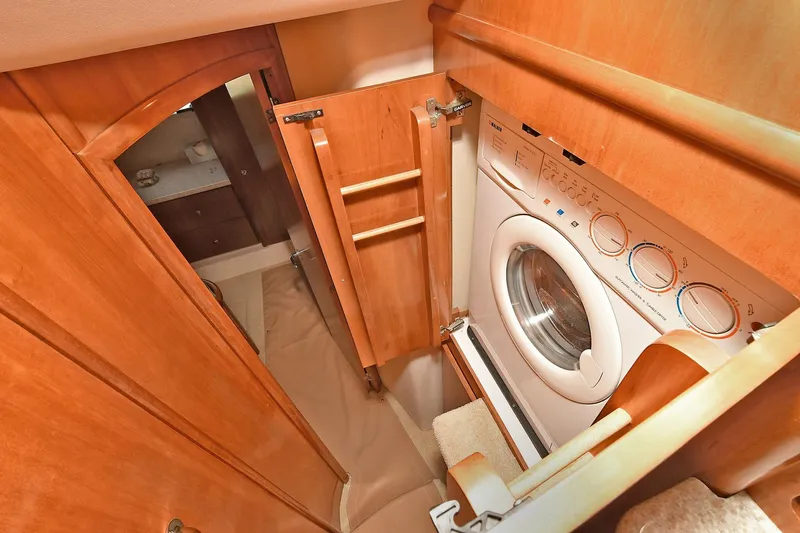  Yacht Photos Pics Laundry area inside 2001 Carver 466 Motor Yacht with wood cabinetry.