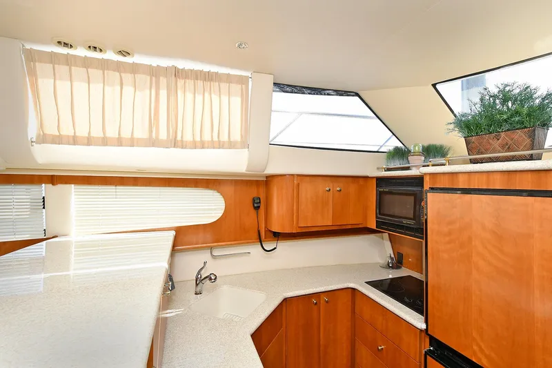  Yacht Photos Pics Interior of 2001 Carver 466 Motor Yacht kitchen with wood cabinets and modern appliances.