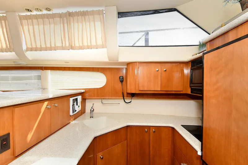  Yacht Photos Pics Interior of 2001 Carver 466 Motor Yacht kitchen with wood cabinets and modern appliances.