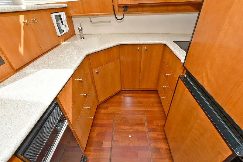  Yacht Photos Pics 2001 Carver 466 Motor Yacht kitchen with wood cabinetry and modern appliances.