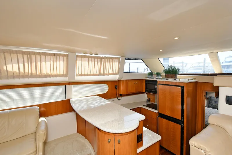  Yacht Photos Pics Luxurious interior of 2001 Carver 466 Motor Yacht with modern kitchen and seating area.