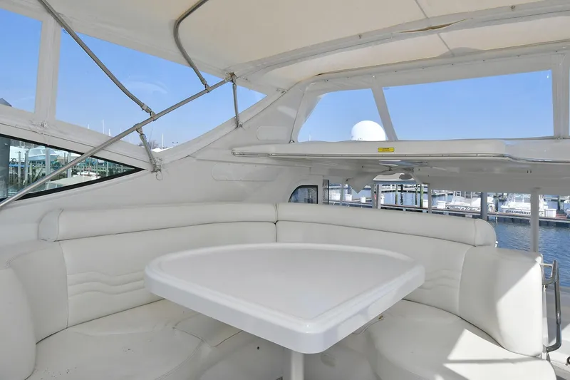  Yacht Photos Pics 2001 Carver 466 Motor Yacht interior with white seating and table, marina view.
