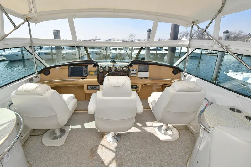  Yacht Photos Pics Interior of 2001 Carver 466 Motor Yacht with helm and seating, docked at marina.