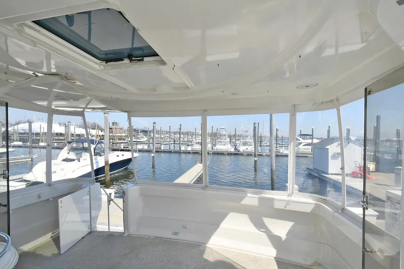  Yacht Photos Pics Interior view of 2001 Carver 466 Motor Yacht at marina, showcasing spacious design and waterfront.