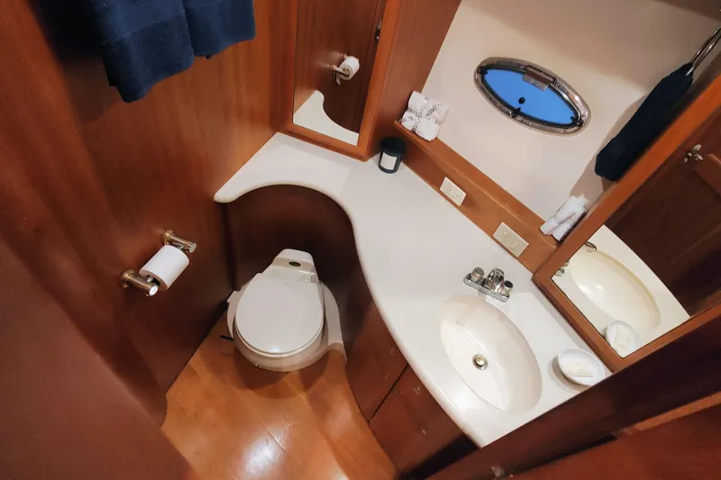 Diversion III Yacht Photos Pics Luxurious bathroom in 2002 Silverton 43 Motor Yacht with wood accents and modern fixtures.