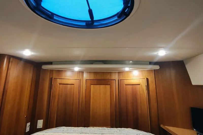 Diversion III Yacht Photos Pics Interior cabin of 2002 Silverton 43 Motor Yacht with wooden paneling and ceiling hatch.