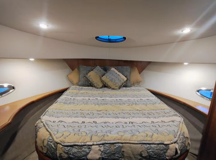 Diversion III Yacht Photos Pics Luxurious bedroom interior of 2002 Silverton 43 Motor Yacht with elegant bedding and ambient lighting.