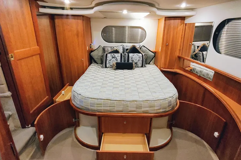 Diversion III Yacht Photos Pics Luxurious bedroom interior of 2002 Silverton 43 Motor Yacht with elegant wood finish.