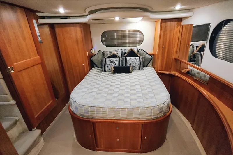 Diversion III Yacht Photos Pics Luxurious cabin interior of a 2002 Silverton 43 Motor Yacht with elegant wood finishes.