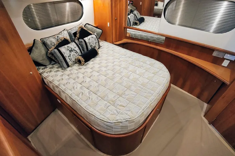 Diversion III Yacht Photos Pics Luxurious bedroom interior of 2002 Silverton 43 Motor Yacht with elegant bedding and wood accents.