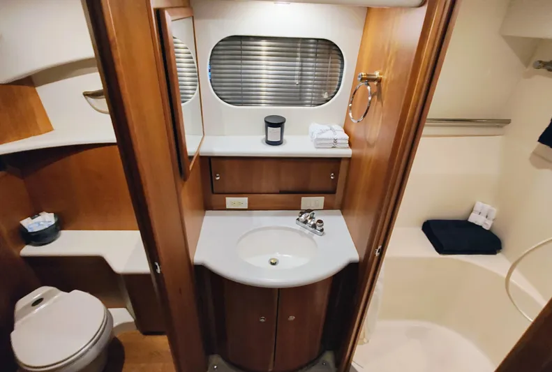 Diversion III Yacht Photos Pics Luxurious bathroom in 2002 Silverton 43 Motor Yacht with wood accents and modern amenities.