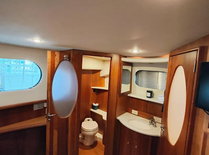 Diversion III Yacht Photos Pics Interior of 2002 Silverton 43 Motor Yacht bathroom with wood accents and modern fixtures.