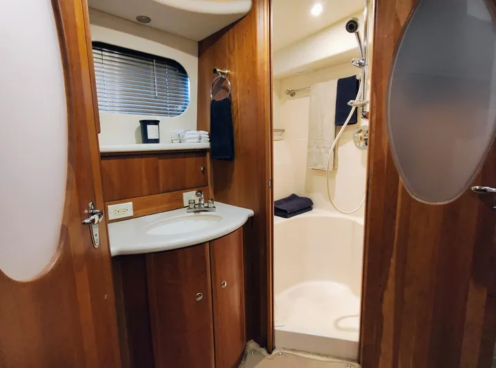 Diversion III Yacht Photos Pics Luxurious bathroom in 2002 Silverton 43 Motor Yacht with wood accents and modern fixtures.