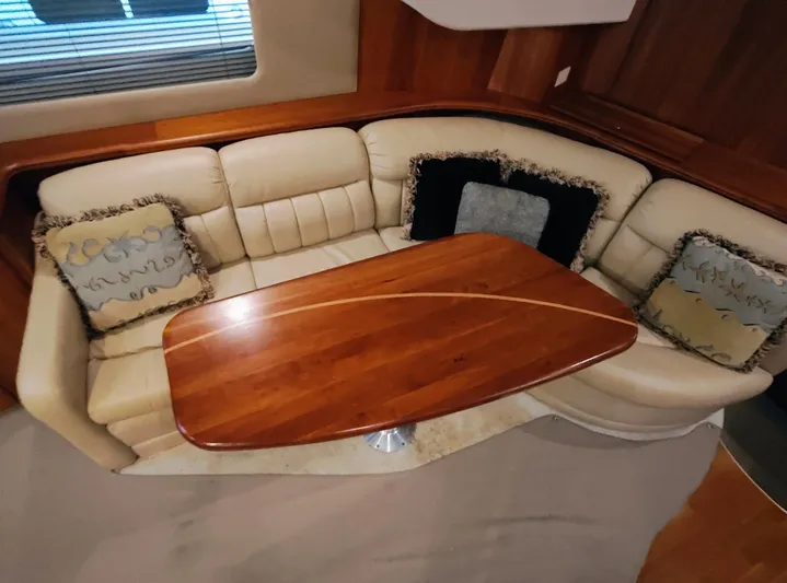 Diversion III Yacht Photos Pics Luxurious interior of 2002 Silverton 43 Motor Yacht with elegant wood table and plush seating.
