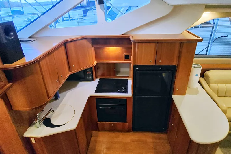 Diversion III Yacht Photos Pics 2002 Silverton 43 Motor Yacht kitchen with wood cabinetry and modern appliances.