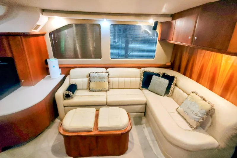 Diversion III Yacht Photos Pics Luxurious interior of 2002 Silverton 43 Motor Yacht with plush seating and elegant wood finishes.