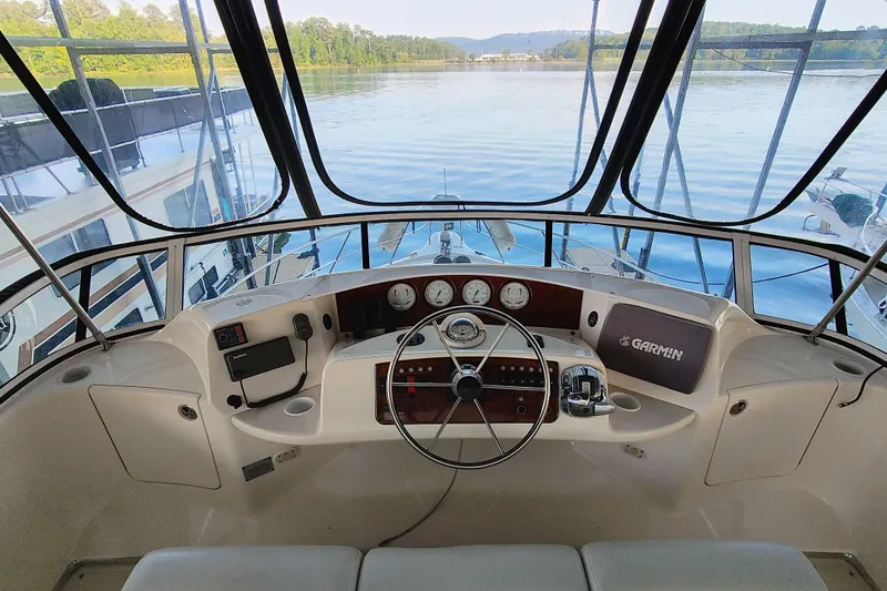 Diversion III Yacht Photos Pics 2002 Silverton 43 Motor Yacht helm with steering wheel and navigation instruments.
