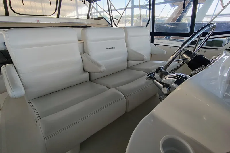 Diversion III Yacht Photos Pics Interior of 2002 Silverton 43 Motor Yacht with white leather seating and steering wheel.