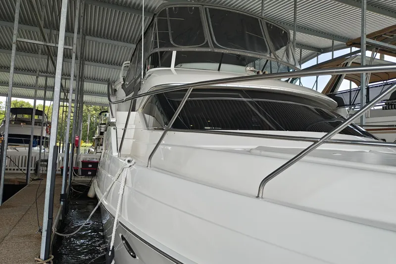 Diversion III Yacht Photos Pics 2002 Silverton 43 Motor Yacht docked in a covered marina.