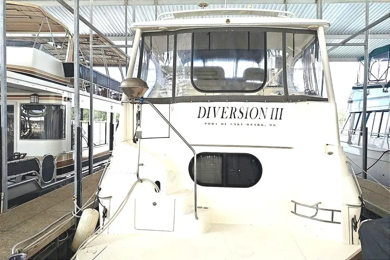 Diversion III Yacht Photos Pics 2002 Silverton 43 Motor Yacht docked in a covered slip.