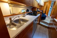 Luxurious 2004 Elling E3 Ultimate yacht kitchen with modern amenities and wooden cabinetry.