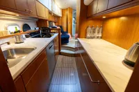Luxurious 2004 Elling E3 Ultimate yacht kitchen with wood cabinetry and modern appliances.