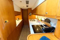 Luxurious 2004 Elling E3 Ultimate yacht kitchen with wooden cabinetry and modern appliances.