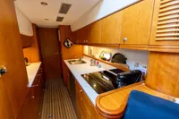 Luxurious kitchen interior of 2004 Elling E3 Ultimate yacht with wooden cabinetry and modern appliances.