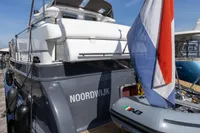 Elling E3 Ultimate 2004 yacht with flag and tender in marina.