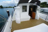2004 Elling E3 Ultimate yacht with teak deck, docked by the water.