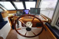 Helm of 2004 Elling E3 Ultimate yacht with navigation equipment and wooden steering wheel.