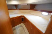 2004 Elling E3 Ultimate yacht cabin with wooden interior and cozy bedding.