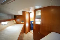 Interior of 2004 Elling E3 Ultimate yacht with wooden finishes and cozy sleeping area.