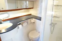Bathroom interior of 2004 Elling E3 Ultimate yacht with shower, toilet, and sink.