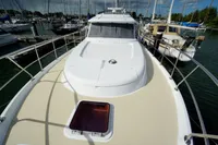 2004 Elling E3 Ultimate yacht docked at marina, showcasing spacious deck and sleek design.