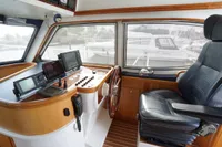 2004 Elling E3 Ultimate yacht helm with navigation equipment and leather captain's chair.