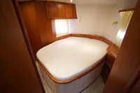 Luxurious cabin interior of 2004 Elling E3 Ultimate yacht with cozy bed and wooden furnishings.