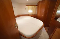 Luxurious bedroom interior of 2004 Elling E3 Ultimate yacht with wooden furnishings.