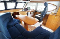 Luxurious interior of 2004 Elling E3 Ultimate yacht with plush seating and navigation controls.