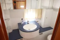Bathroom interior of 2004 Elling E3 Ultimate yacht, featuring modern fixtures and wood flooring.