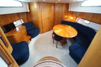 Luxurious 2004 Elling E3 Ultimate yacht interior with wooden furnishings and blue seating.